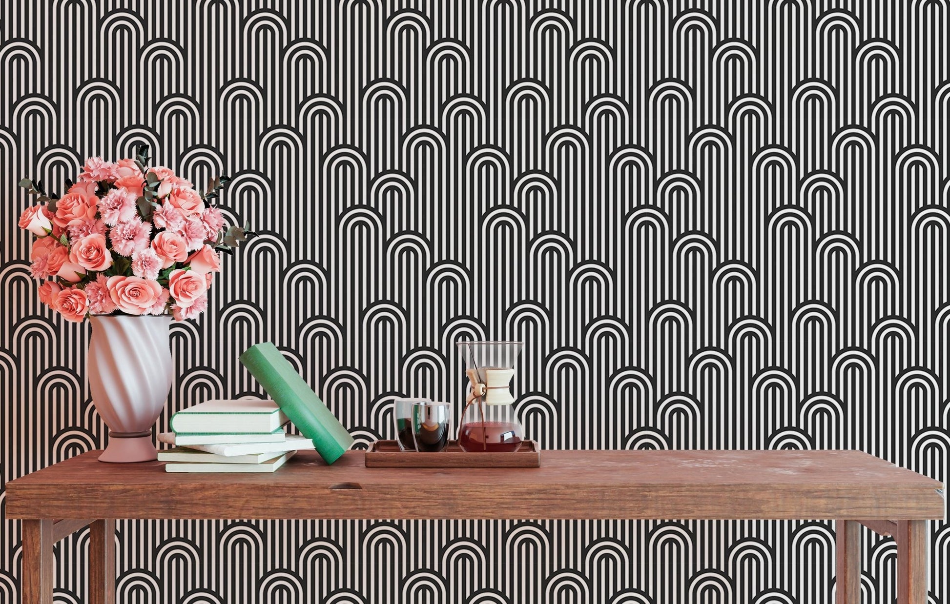 Black and white geometric wallpaper behind a console with pink flowers