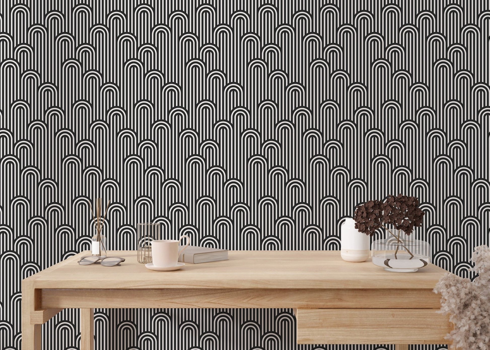 Minimalist black and white striped wallpaper behind a home office desk