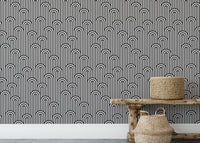 Stripy weaving black and white wallpaper behind a rustic wooden bench