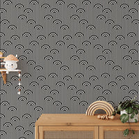 Black and white stripy weaving wallpaper above a wooden sideboard