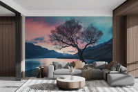 Minimalist mountain view wall mural with silhouetted tree trunk.