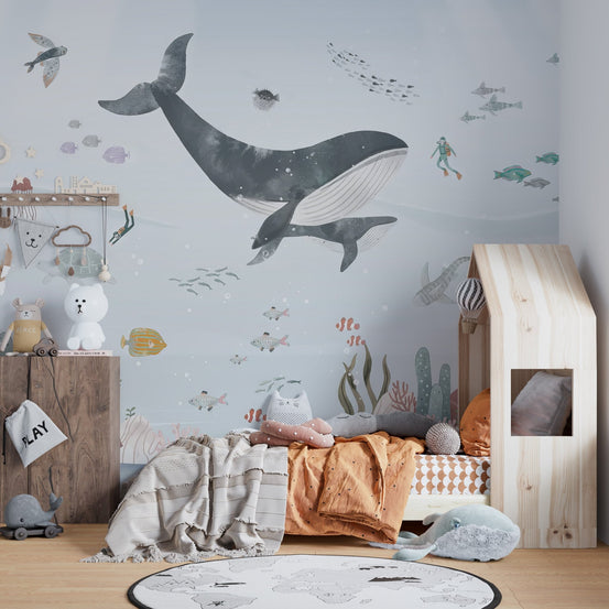 Undersea life wall mural with whale and pastel coral wallpaper.