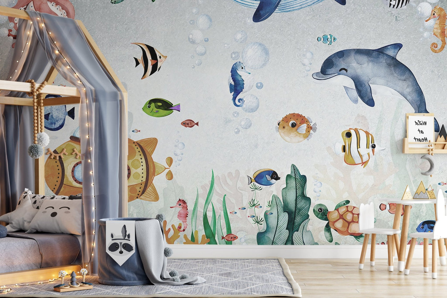 Sea creature life wall mural with an octopus and whale in a kids bedroom.