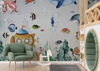 Underwater Fish & Marin Life mural on a nursery wall with a green armchair.