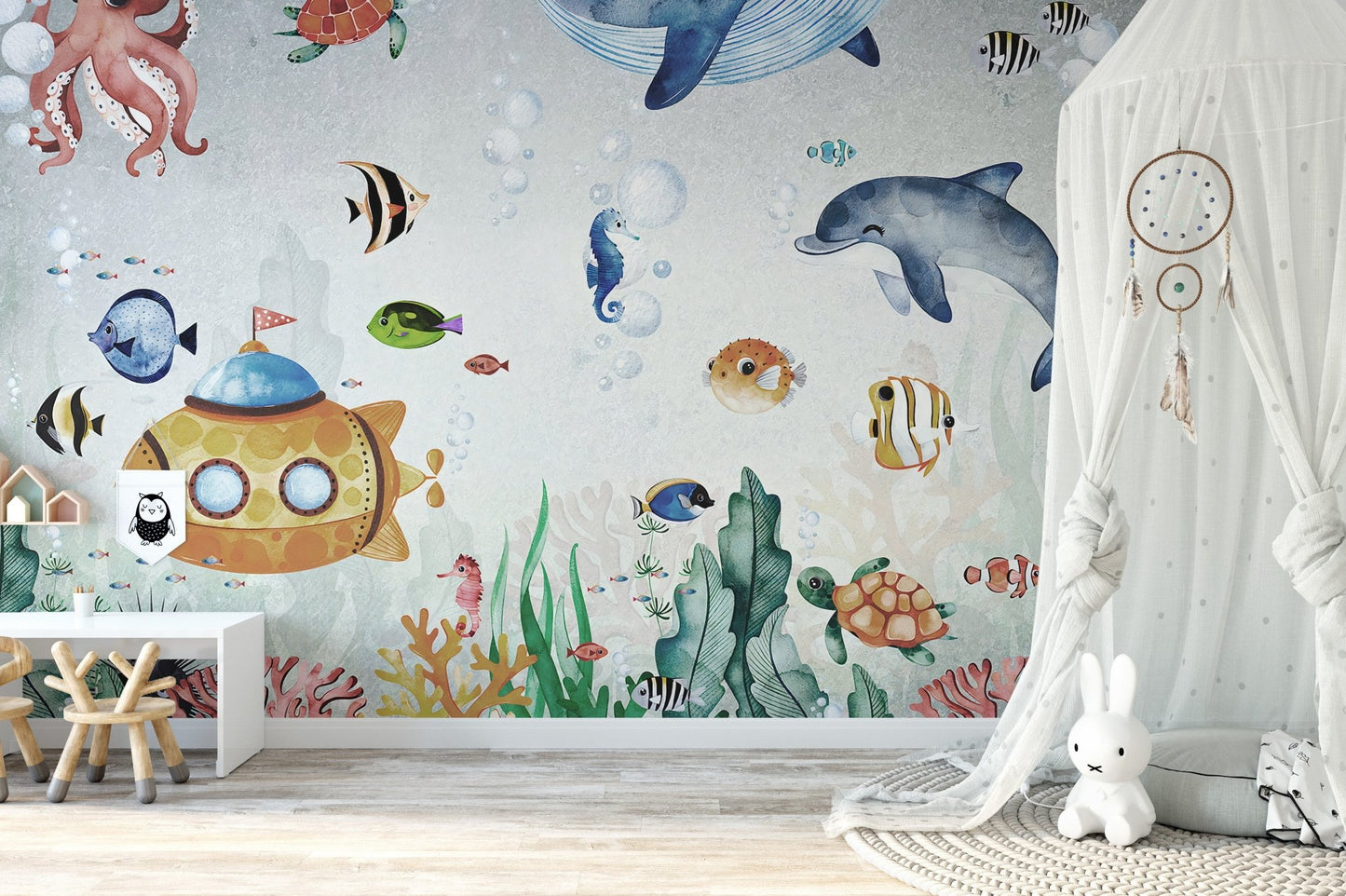 Marine life wall mural with dolphins and an octopus behind a white canopy bed.