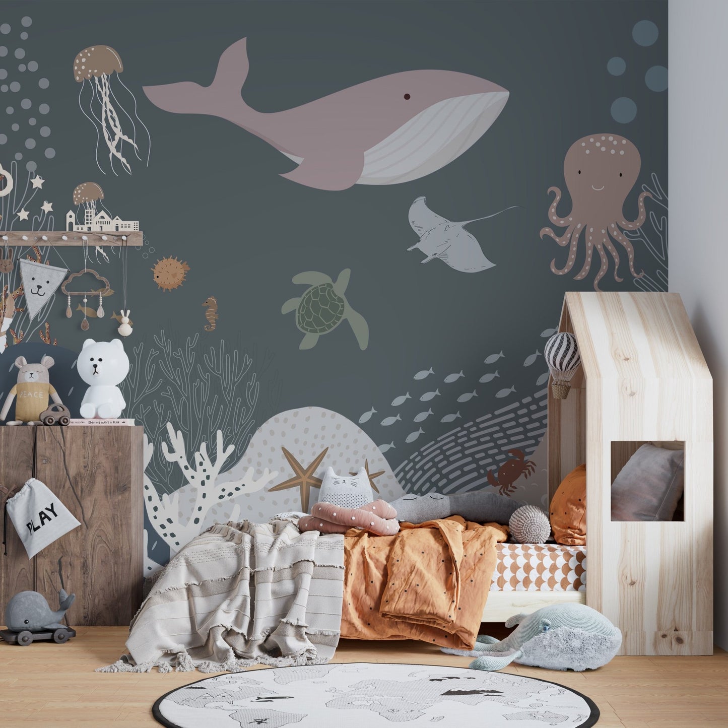 Cheerful jellyfish and starfish in an ocean life mural for kids bedroom.
