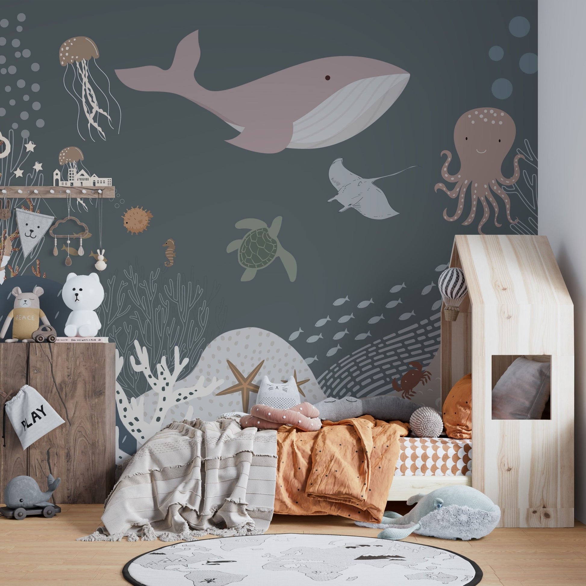 Cheerful jellyfish and starfish in an ocean life mural for kids bedroom.
