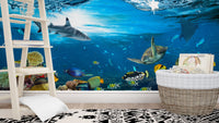 Nursery room with white ladder shelf and underwater creature wall mural.