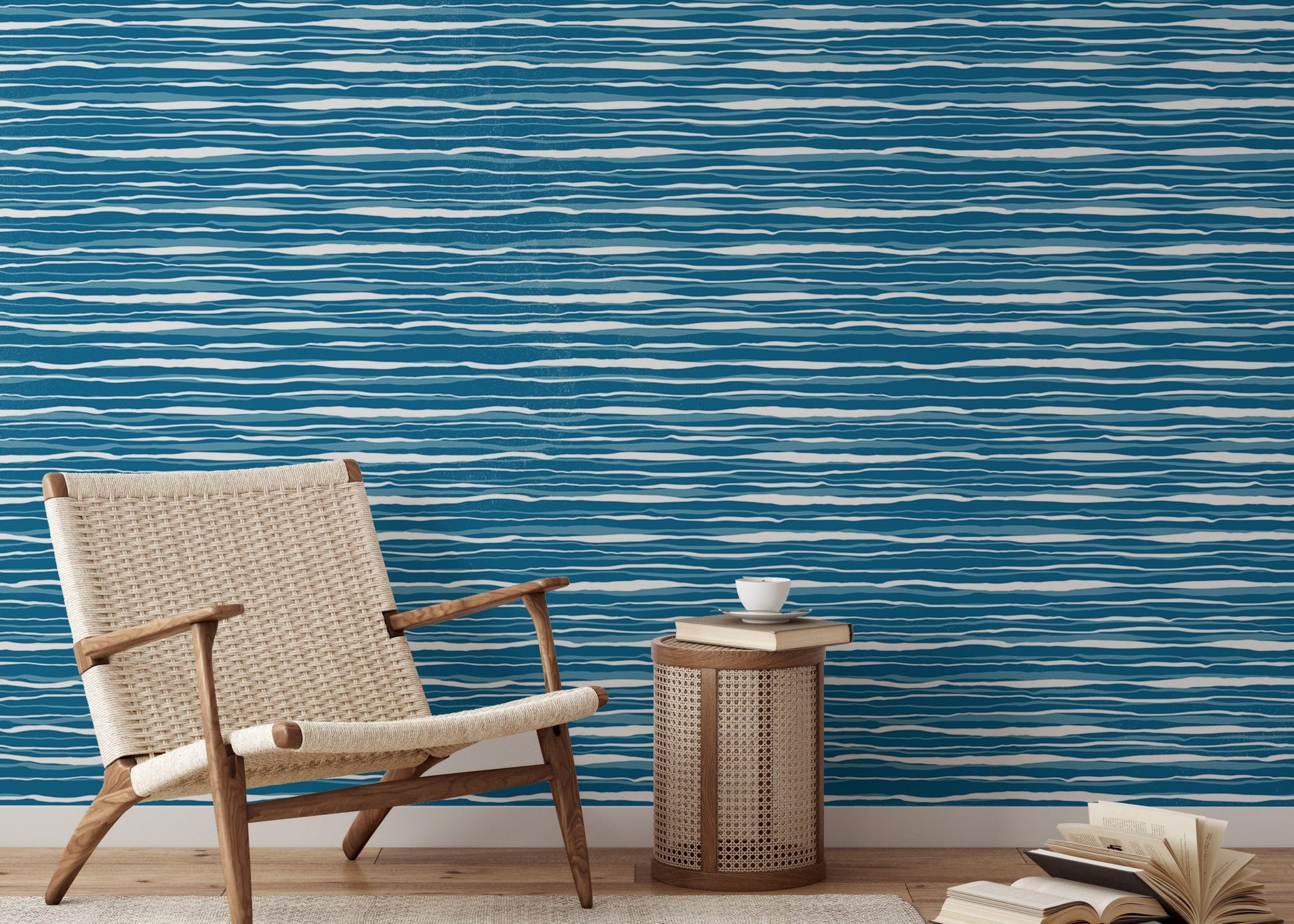 Modern reading area with blue ocean waves wallpaper and a woven chair.