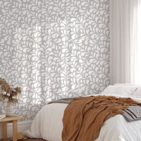 Seamless white drops damask wallpaper in a bedroom with natural sunlight.
