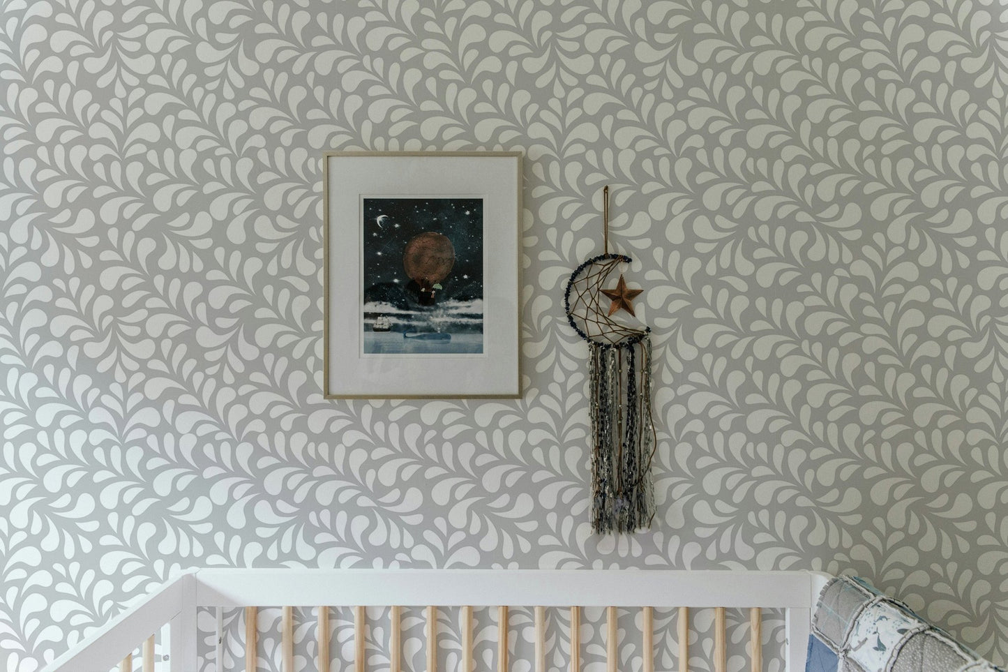Minimalist damask wallpaper in a nursery with framed wall art.