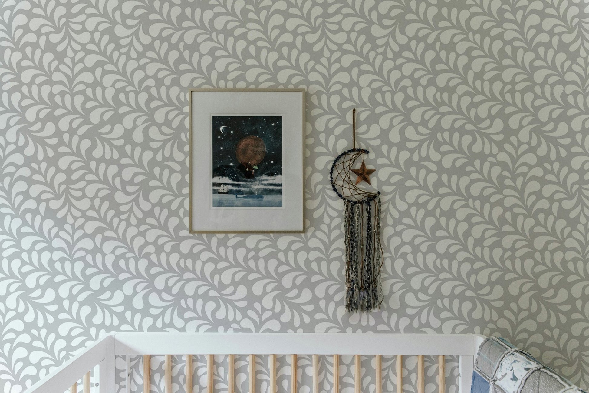 Minimalist damask wallpaper in a nursery with framed wall art.