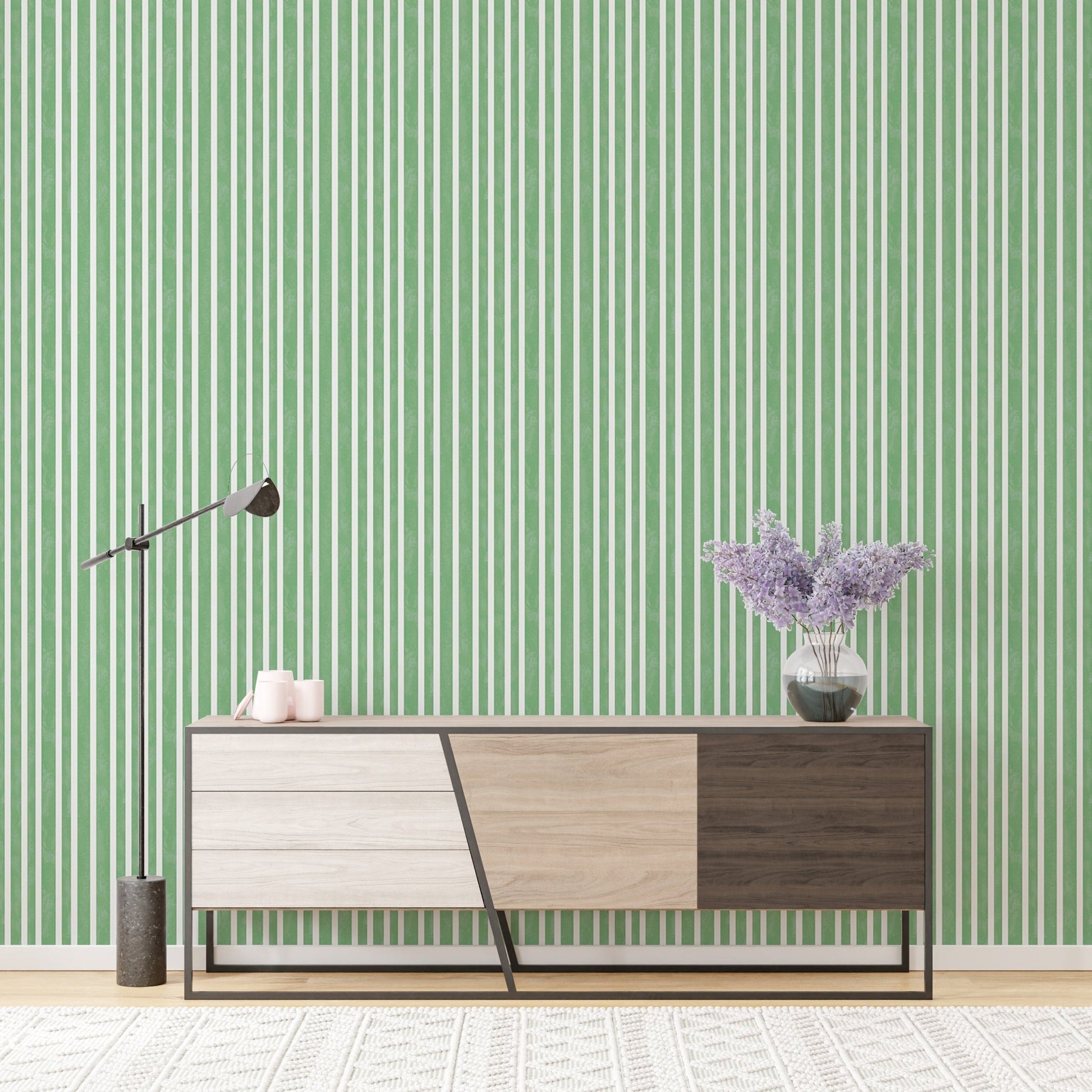 Console table against watercolor green stripes vintage wallpaper.