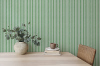 Study area desk with green vertical striped wallpaper background.