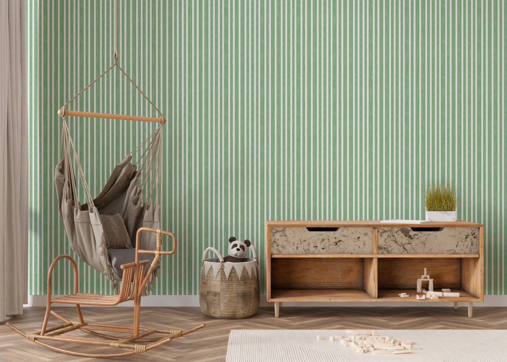 Living corner with hanging chair and green striped wallpaper.
