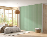 Bedroom wall decor showing vertical watercolor green wallpaper.
