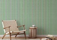 Reading nook featuring light green striped wallpaper and armchair.
