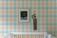 Blue and pink stripe wallpaper for a nursery with a white crib.