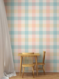 Vichy pattern wallpaper behind a small wooden dining table and chairs.