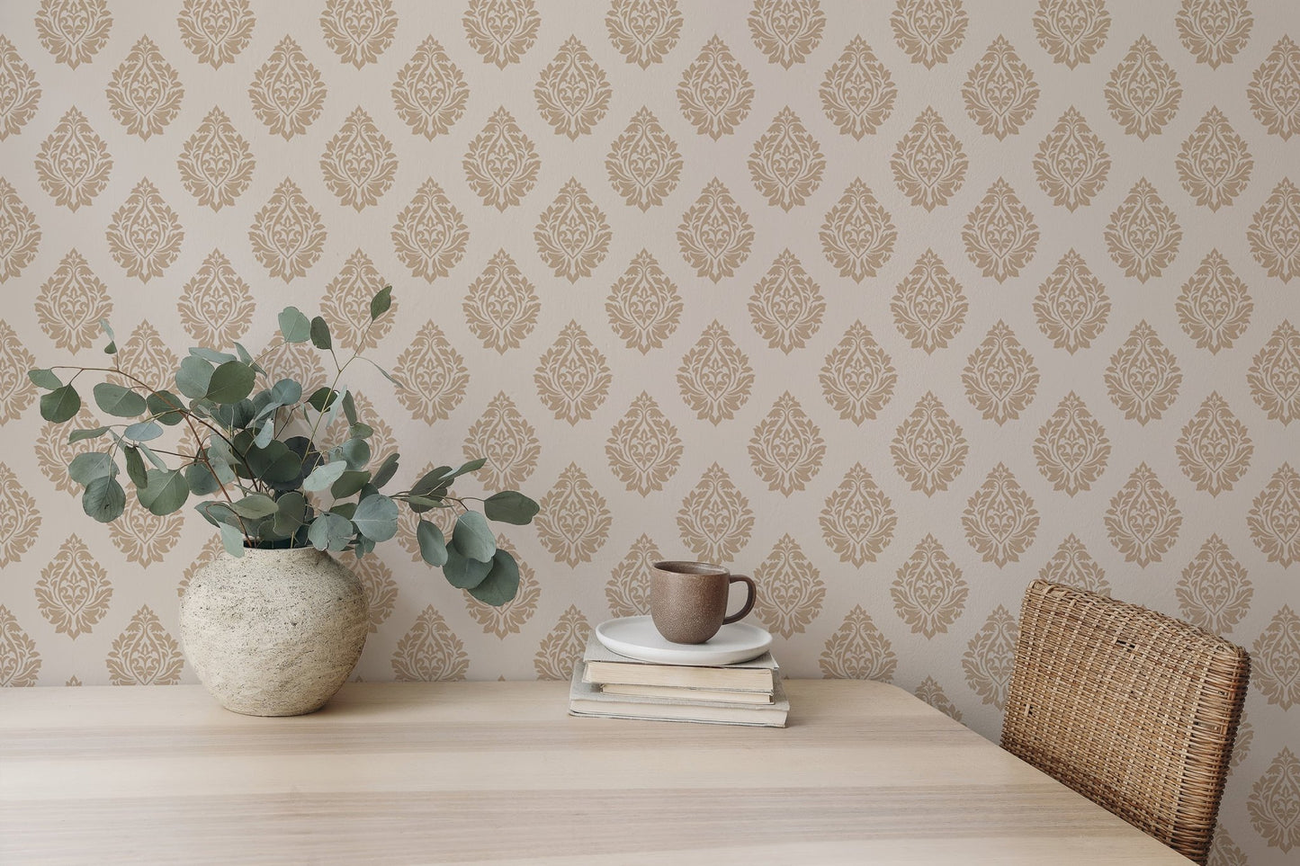 Damask wallpaper in a minimalist dining room with eucalyptus in a vase.