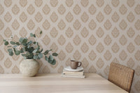 Damask wallpaper in a minimalist dining room with eucalyptus in a vase.