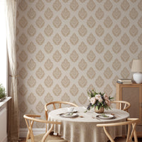 Repeat pattern wallpaper in a dining space with a round table and wooden chairs.