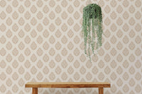 Brown butta wallpaper featuring a hanging green plant over a wooden bench.