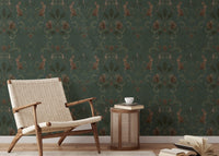 Green woodland animal wallpaper with a beige chair and side table in reading area.