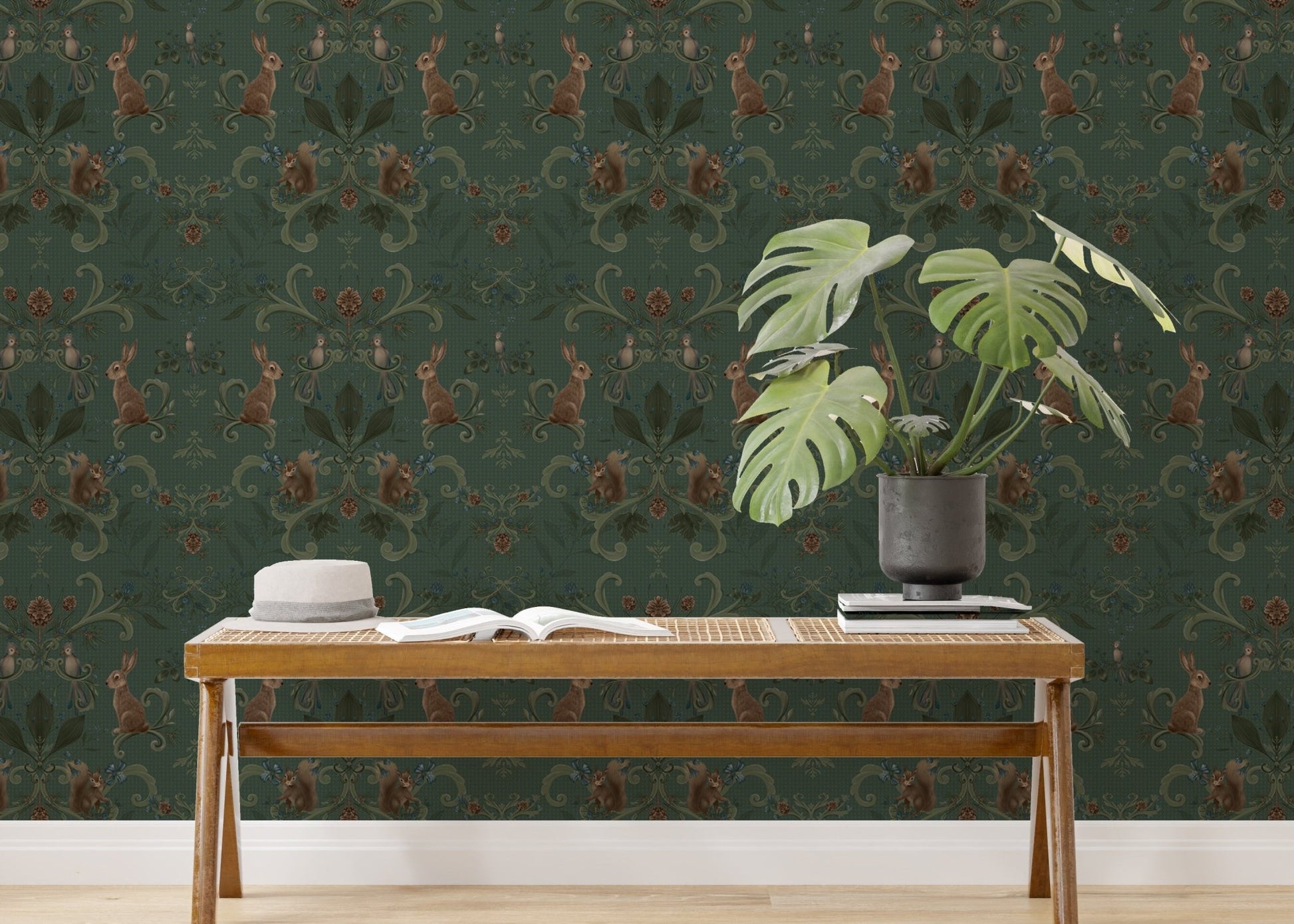 Woodland animals wallpaper in a study space with a wooden desk and plant.
