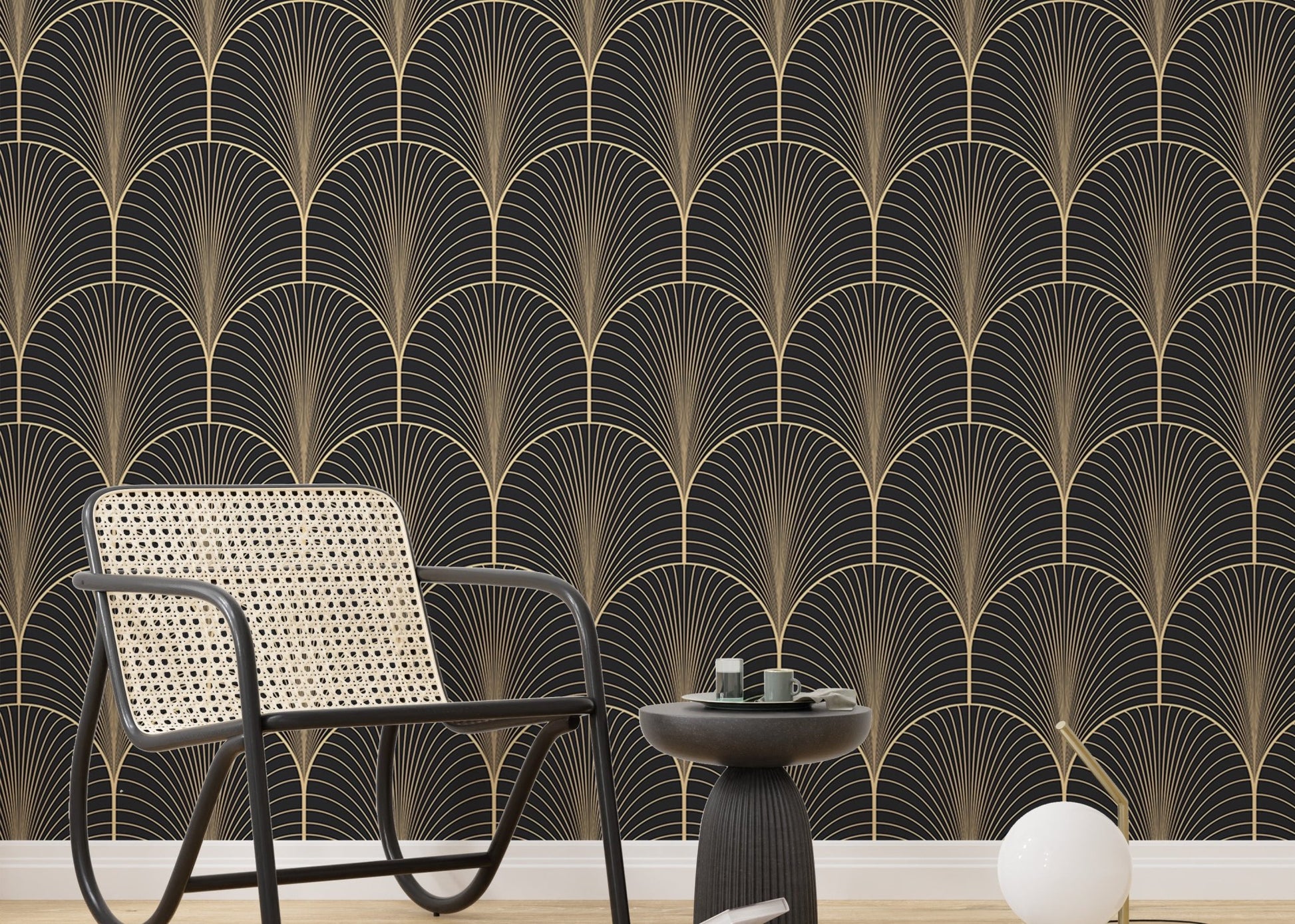 Art Deco pattern wallpaper behind black metal chair and side table.
