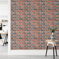 Hallway corner with a small table and brick wall paper.