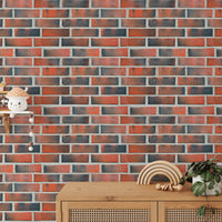 Sideboard with plants against a burned red brick wallpaper.