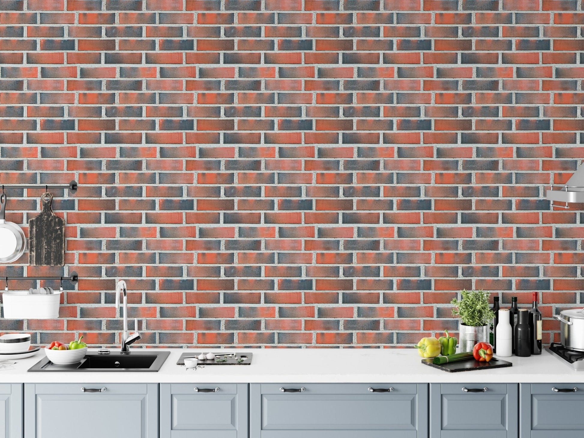 Kitchen counter with a grey and red brick wallpaper backdrop.