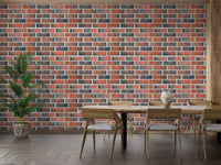 Dining area with wooden table and industrial brick wallpaper.