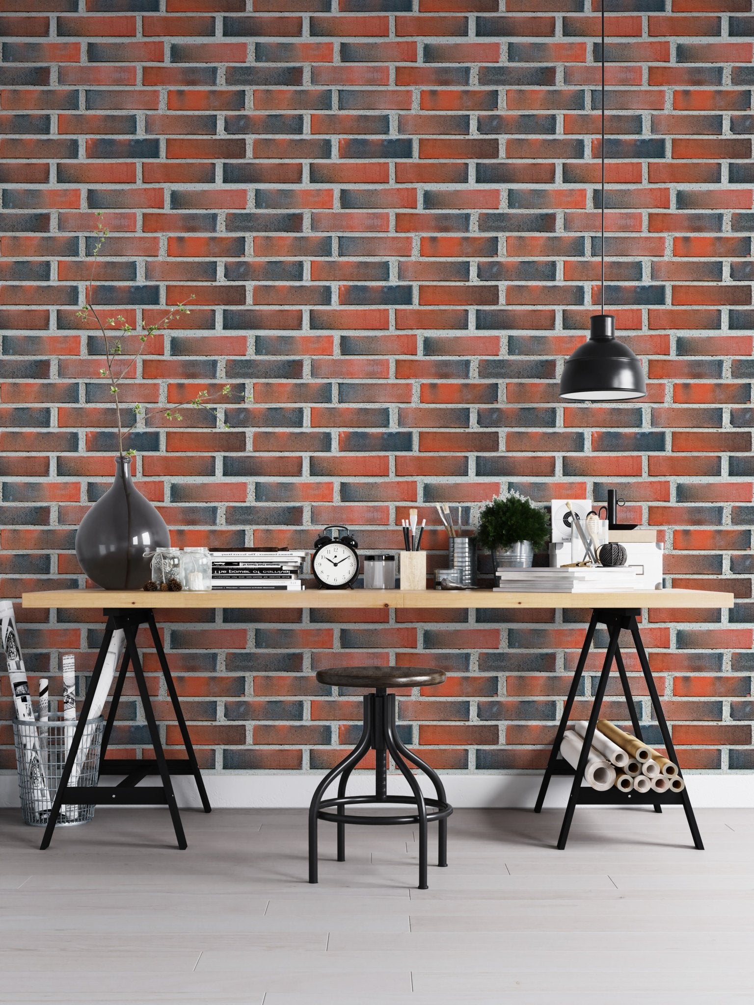Home office desk setup with a red lining brick wallpaper.