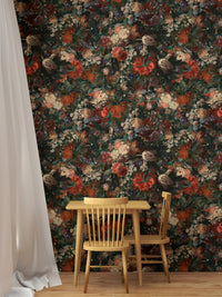 Vintage floral wallpaper behind a small wooden table and chairs set in dining area.