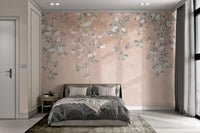 Muted peach floral wall mural with green leaf patterns for sunlit bedroom.