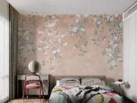 White floral branch wall mural on a textured peach surface for bedroom.