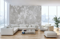 Large floral wallpaper in a spacious white living room with a couch.