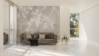 Textured grey wall mural with white floral art in a living space.
