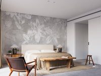 Grey floral wallpaper mural in a neutral bedroom with a wooden bench.