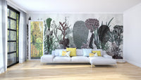 Abstract green cactus wall mural behind a white sectional sofa in a large living room.