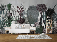 Artistic green plant wall mural in a kids playroom with white furniture and small rug.


