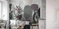 Modern floral wall mural with dark foliage in a bright flat with white doors.