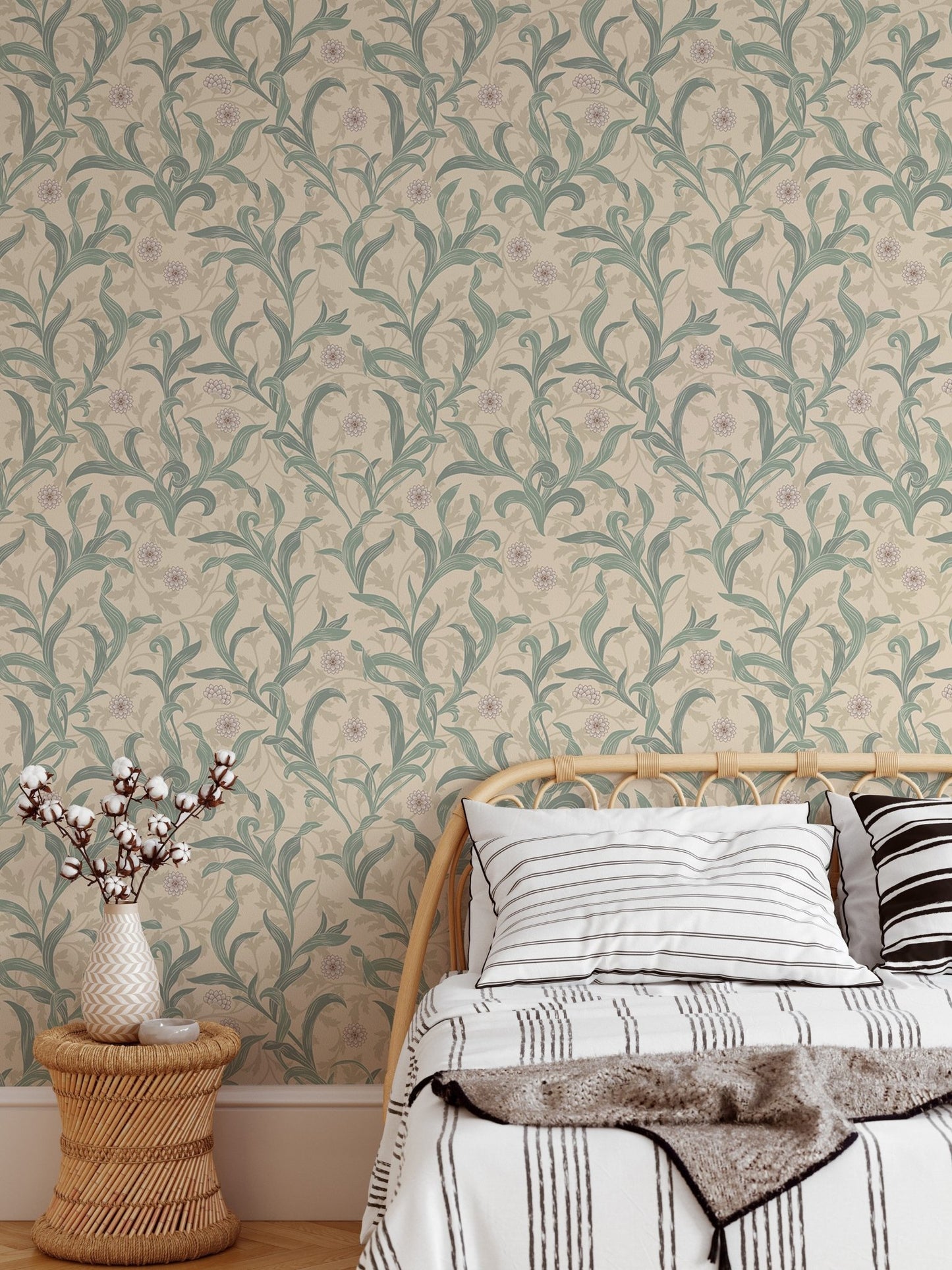 Toddler bed placed against a green botanical patterned wallpaper.