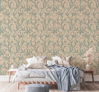 Vintage floral wallpaper behind a white bed with blue throw blanket.