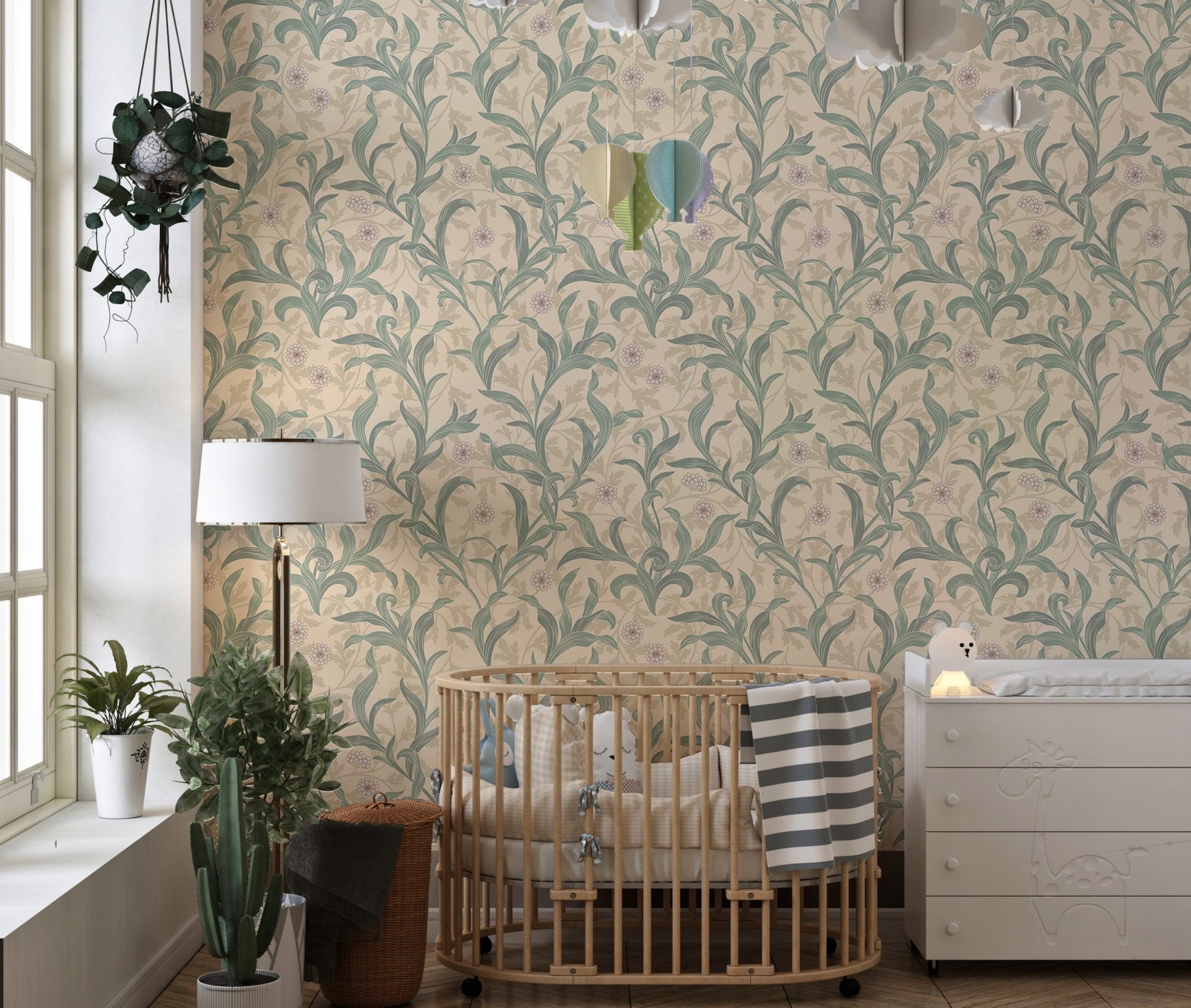 Nursery room wall decorated with sage green vine patterned wallpaper.