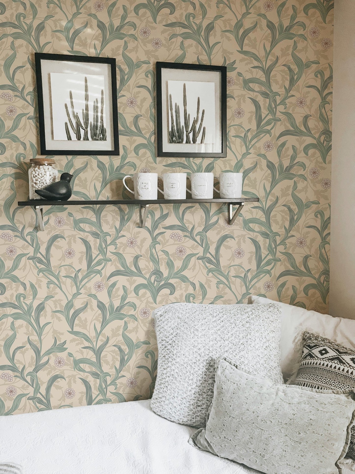 Vintage flower wallpaper behind a white pillow with black frame.