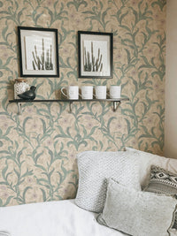 Vintage flower wallpaper behind a white pillow with black frame.