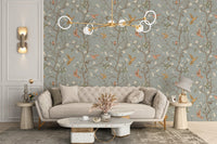 Elegant beige sofa set against a bird and flower wallpaper in a bright living area.